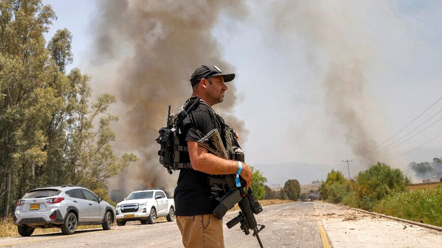 Israeli security forces deploy near a site where rockets fired from south Lebanon landed near Kfar Szold in the Upper Galilee in northern Israel on June 14, 2024