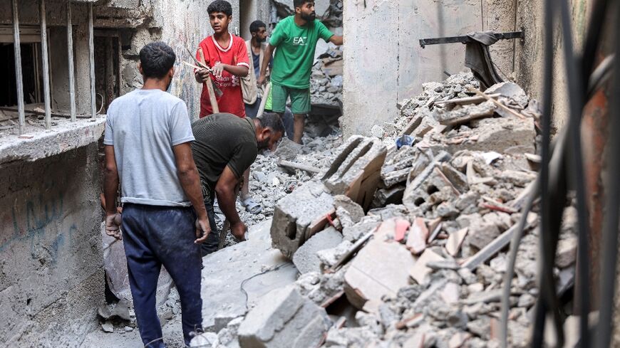 Men search through the rubble after an Israeli strike on the Haniyeh family home in northern Gaza