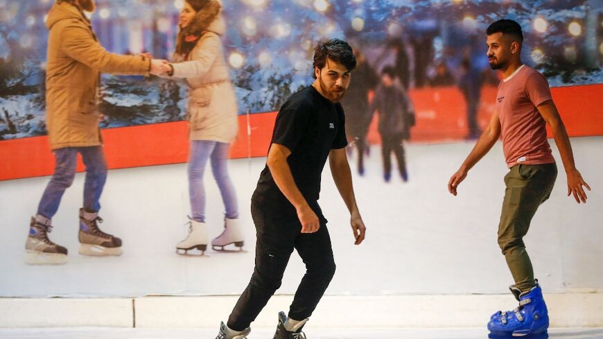 Iraqis skate at the Zayouna Mall ice skating rink in the capital Baghdad