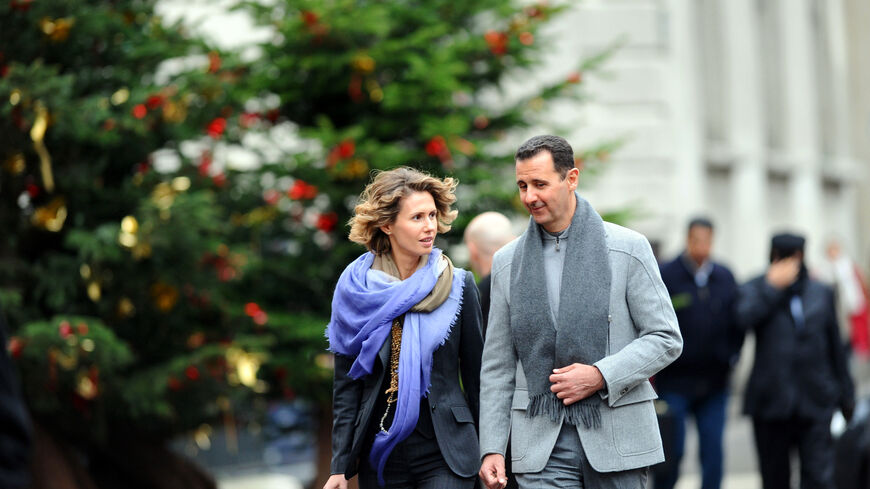 Syrian president Bashar al-Assad and his wife Asma walk in a street of Paris on December 10, 2010. Al-Assad is on a two-days official visit to France. AFP PHOTO MIGUEL MEDINA (Photo credit should read MIGUEL MEDINA/AFP via Getty Images)