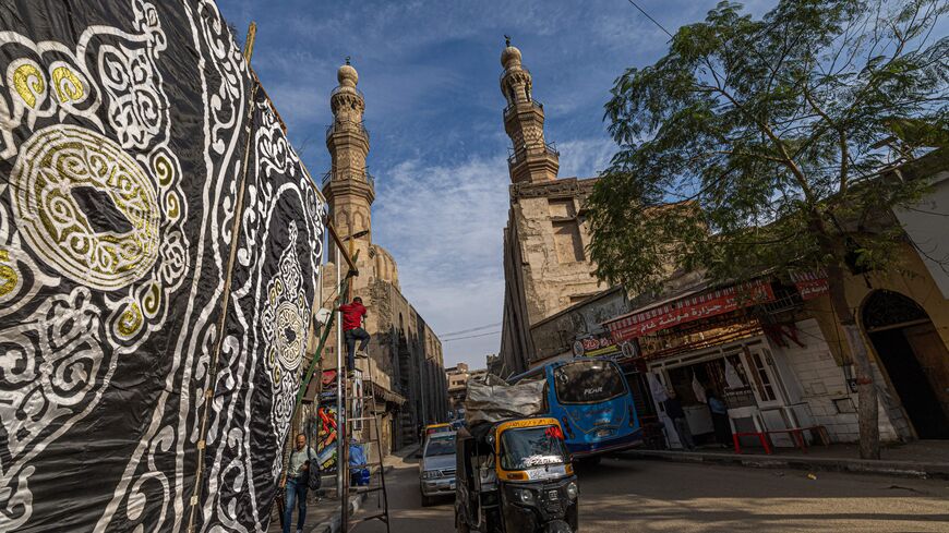 An Egyptian man drives a tuk-tuk (motorised rickshaw) in the al-Khalifa district of Egypt's capital Cairo on January 11, 2023. - With Egypt's economy in crisis, the currency in freefall and inflation skyrocketing, the poor have been hit hard but the middle class is also teetering on the brink. (Photo by Khaled DESOUKI / AFP) (Photo by KHALED DESOUKI/AFP via Getty Images)