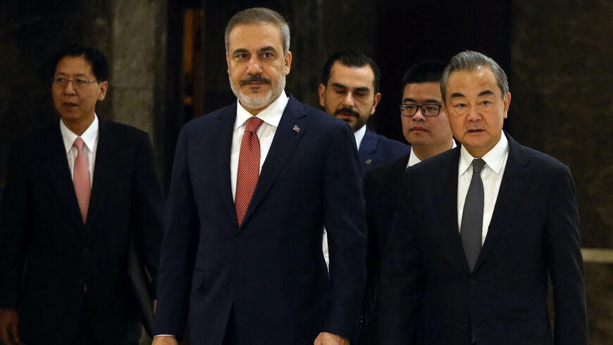 Turkish Foreign Minister, Hakan Fidan (C) welcomes his Chinese counterpart and Director of the Office of the Central Foreign Affairs Commission, Wang Yi (R) in Ankara, on July 26, 2023.