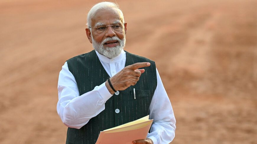 India's Prime Minister Narendra Modi gestures before his speech as he holds a letter by President Droupadi Murmu (not pictured) requesting him to form the country's new government, at the presidential palace Rashtrapati Bhavan in New Delhi on June 7, 2024. 