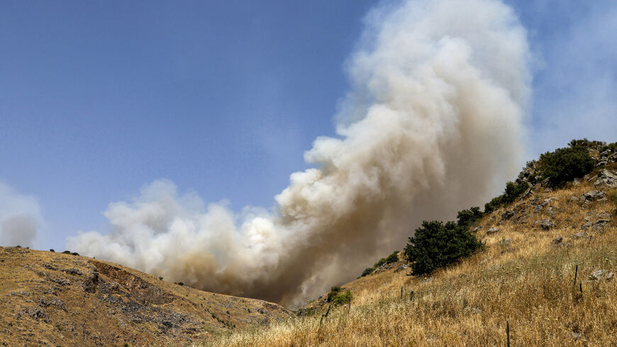 CORRECTION / Smoke plumes rise from a fire in a field after rockets launched from southern Lebanon landed near Kela in the Israel-annexed Golan Heights on June 13, 2024 amid ongoing cross-border clashes between Israeli troops and Hezbollah fighters. (Photo by Jalaa MAREY / AFP) / "The erroneous mention[s] appearing in the metadata of this photo by Jalaa MAREY has been modified in AFP systems in the following manner: [Kela] instead of [Katzrin]. Please immediately remove the erroneous mention[s] from all you