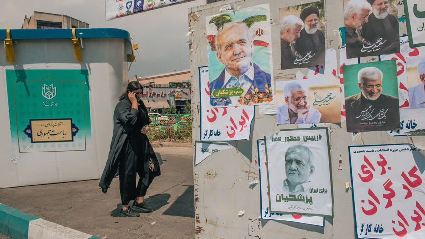 An Iranian woman without wearing mandatory headscarves walks past electoral posters in Tehran, Iran, on June 20, 2024. Iran is holding snap presidential elections to choose the next president after the death of Ebrahim Raisi in a helicopter crash. People in Iran are increasingly showing less interest in casting their vote in the snap presidential election scheduled on June 28 after the disqualification of several candidates by the country's religious Guardian Council. Voter turnouts have hit historically lo