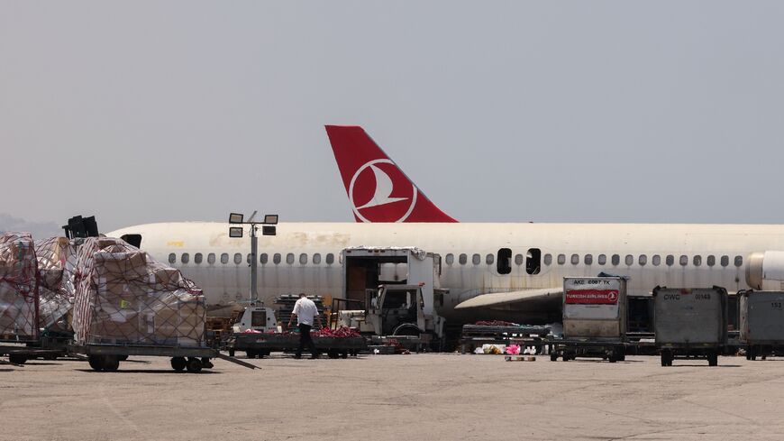 A photo taken during a tour organized by the Lebanese Ministry of Public Works and Transport shows staff loading cargo onto a plane at Beirut's international airport on June 24, 2024.