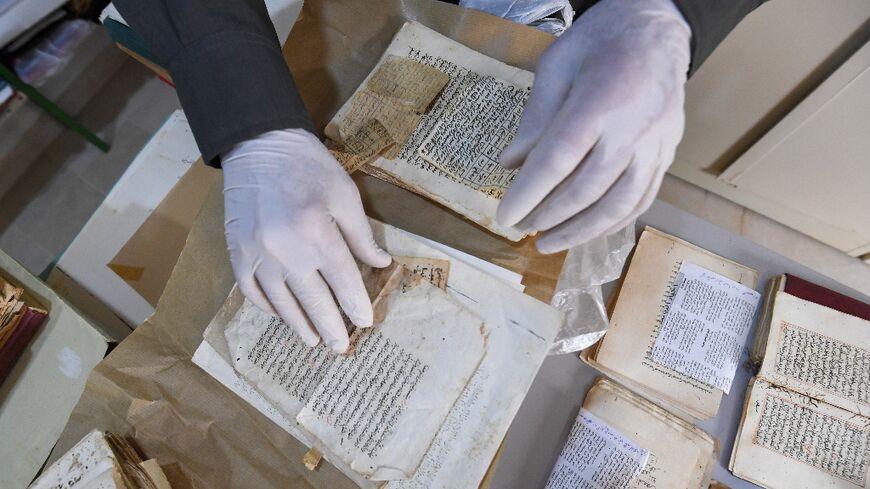 Said al-Barouni prepares to scan old manuscripts at his library