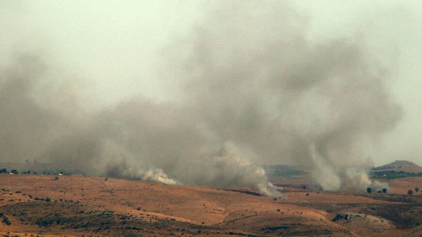 A picture taken from the southern Lebanese area of Marjayoun on July 3, 2024 shows smoke billowing over hills in the Israeli-annexed Golan Heights after rockets were fired from the Lebanese side of the border