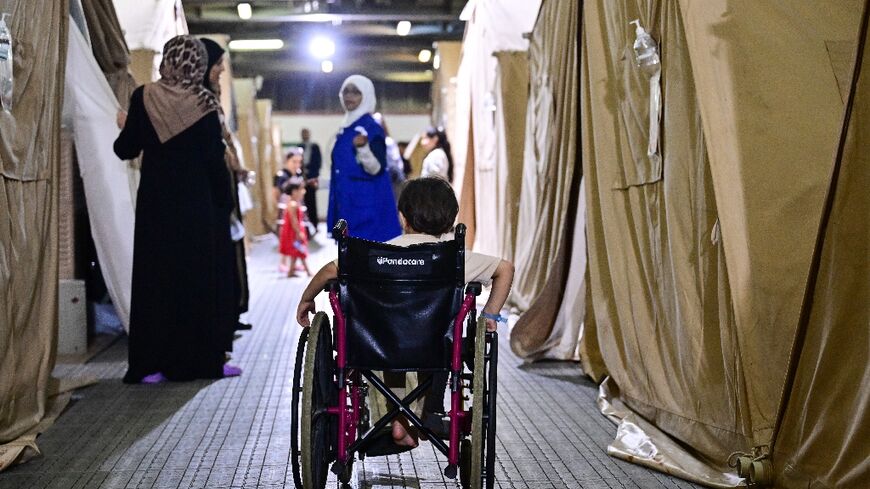 An injured Palestinian boy evacuated from the Gaza Strip uses a wheelchair inside an Emirati floating hospital in the Egyptian port of Al-Arish