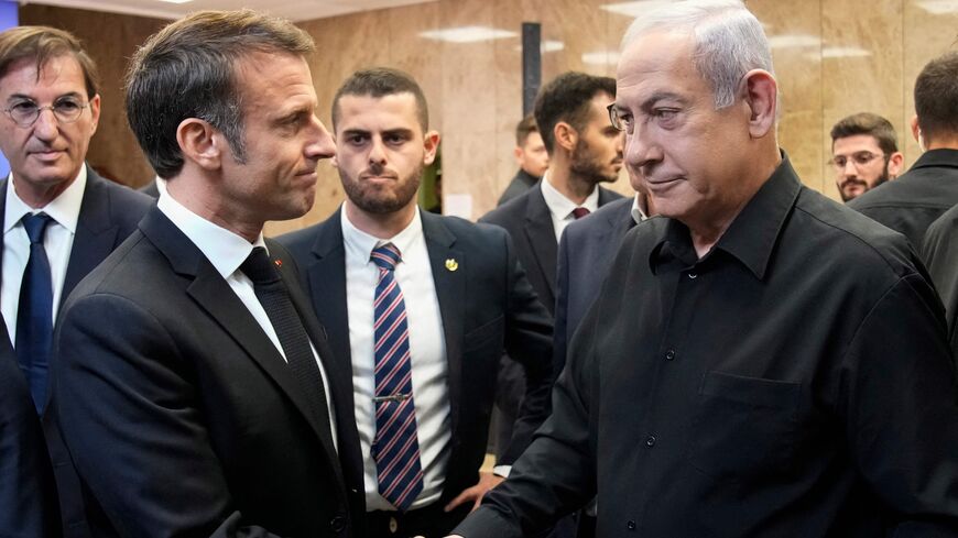 Israeli Prime Minister Benjamin Netanyahu (R) shakes hands with French President Emmanuel Macron (L) after a joint press conference in Jerusalem, Oct. 24, 2023.