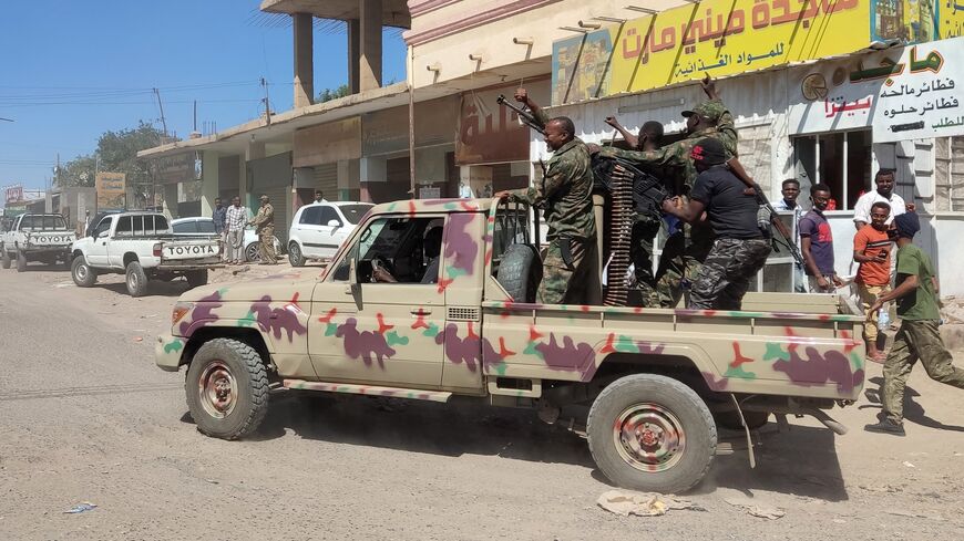 Sudanese soldiers and enrolled personnel drive a pickup truck mounted with a machine gun on a street in Gedaref city, Sudan, on Jan. 14, 2024.