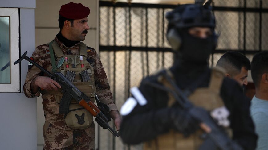 A paramilitary of the Hashed al-shaabi (Popular Mobilisation) forces stands guard during the funeral of a comrade, who died in American air strikes targeting Iran-backed groups the day before, at the Hashed al-shaabi forces' headquarters in Baghdad on January 25, 2024. 