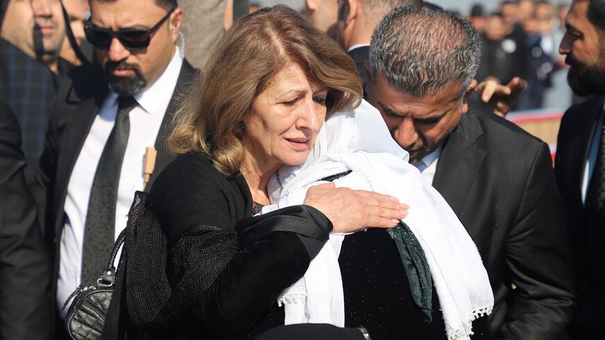 Shanaz Ibrahim Ahmed (L), the wife of Iraqi President Abdul Latif Rashid, comforts a Kurdish woman during a ceremony marking the Anfal mass killings, after corpses were transferred from Baghdad to the Kurdish town of Chamchamal for burial, on February 21, 2024.