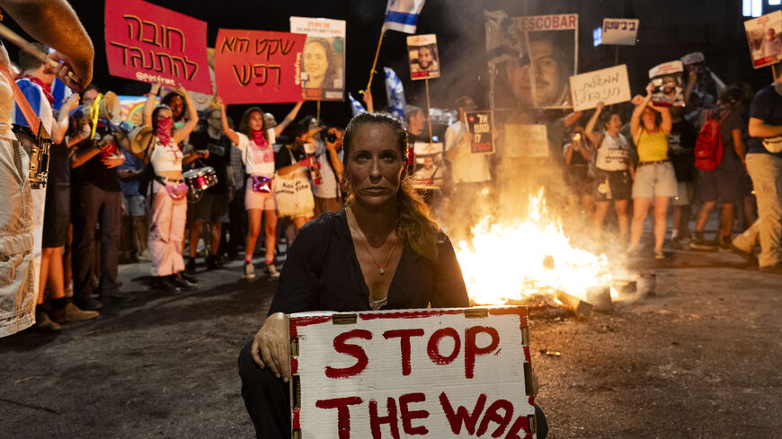 TEL AVIV, ISRAEL - JUNE 29: Families of hostages and supporters set a fire during a demonstration calling for an hostages deal and against the Israeli Prime Minister Benjamin Netanyahu on June 29, 2024 in Tel Aviv, Israel. Saturday night anti-government protest have occurred weekly for months, amid calls by many Israelis for Prime Minister Netanyahu to prioritize the return of hostages held in Gaza over the defeat of Hamas. Netanyahu has recently distanced himself further from a US-backed ceasefire proposal