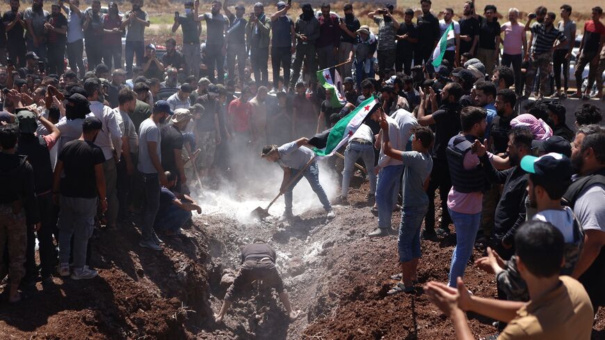 Syrians attend the burial of a man killed during clashes with Turkish troops, in Afrin in northern Syria on July 2, 2024.