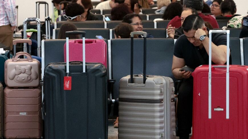 Passengers crowded into airports to wait for news as dozens of flights were cancelled