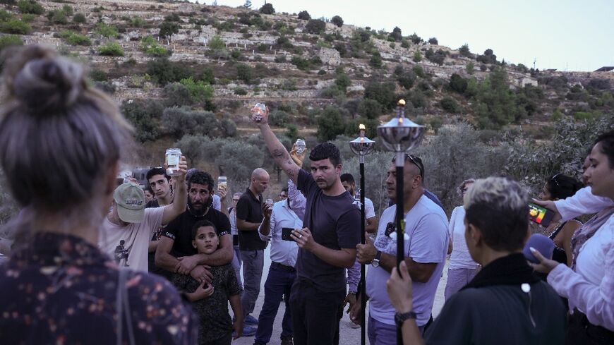 Activists try to reach a land confiscated by Israeli settlers in the al-Makhrur area, near Beit Jala in the Israeli occupied West Bank, on August 15, 2024