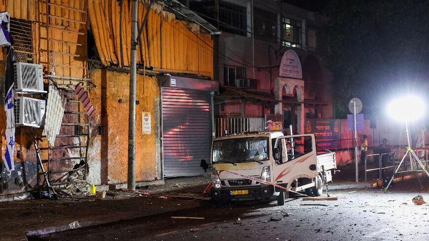 Israeli security and emergency personnel cordon off the site of the blast in Tel Aviv