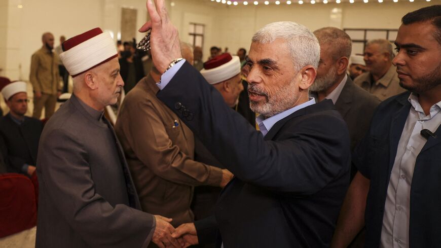 Head of the political wing of the Palestinian Hamas movement in the Gaza Strip Yahya Sinwar (2nd-R) is greeted upon his meeting to a gathering in Gaza City on April 30, 2022. (Photo by MAHMUD HAMS / AFP) (Photo by MAHMUD HAMS/AFP via Getty Images)