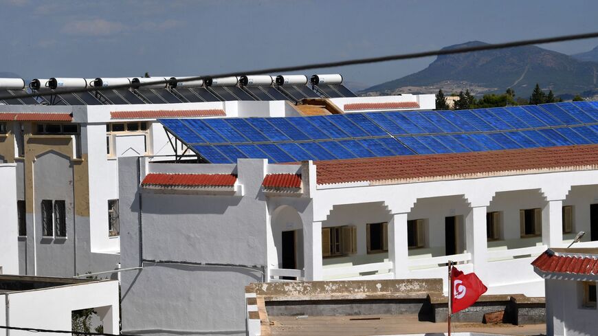 Solar pannels cover the rooftops of the buildings of the Makhtar boarding school on September 29, 2022, in the Tunisian central-west region of the same name. - The Makthar boarding school, a unique business initiative is both generating income and opening pupils' minds to the outside world. Lotfi Hamadi, founder of the NGO "Wallah (Swear to God) We Can", is hoping that helping schools boost their resources through food and energy production can breathe new life into Tunisia's failing, cash-strapped educatio