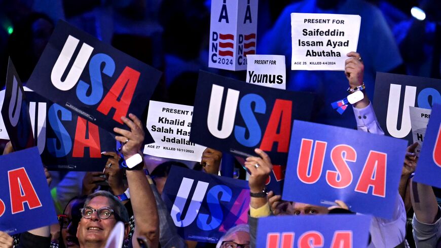 Attendees hold up signs with the names of people who died in the Gaza war on the second day of the Democratic National Convention (DNC) at the United Center in Chicago, Illinois, on August 20, 2024.