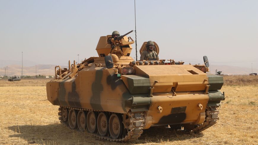 A soldier rides on a Turkish armored vehicle near the Habur crossing gate between Turkey and Iraq during a military drill on September 18, 2017. 