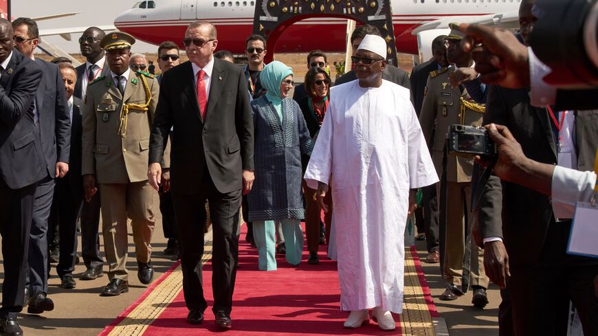 Malian President Ibrahim Boubacar Keita (R) welcomes Turkish president Recep Tayyip Erdogan (L) upon his arrival at Bamako airport on March 2, 2018.