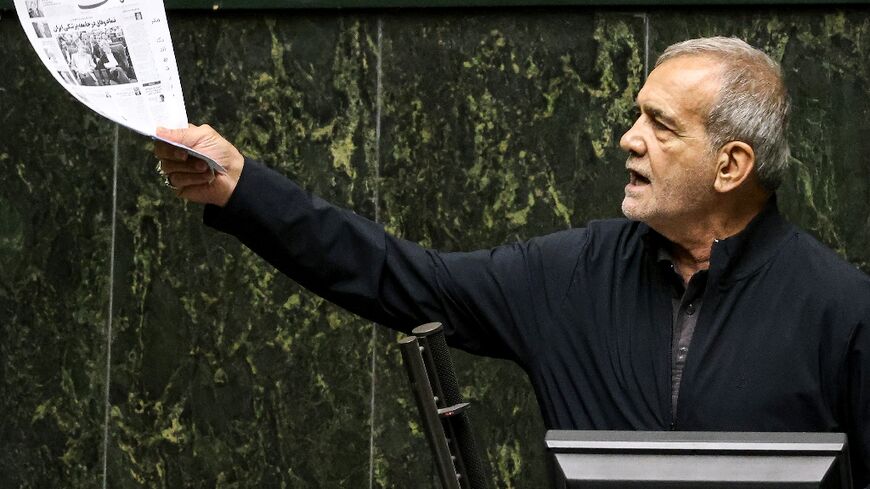 Iran's President Masoud Pezeshkian addresses parliament during a session to approve his new cabinet