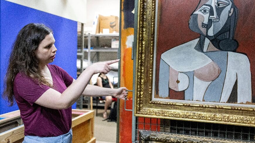 Nathalie Andrijasevic, an assistant curator at the Tel Aviv Museum of Art, points to a painting by Pablo Picasso that was moved to an underground safe room