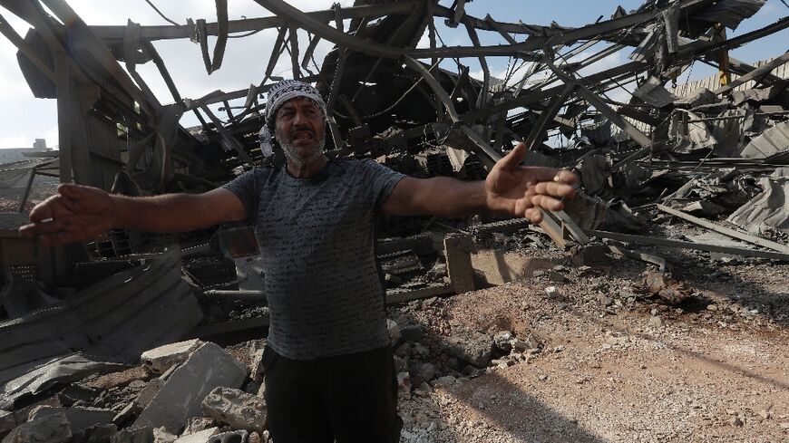 A man inspects damage after an Israeli strike in the southern Lebanese town of Kafur, Nabatiyeh, which Lebanon's health ministry said killed 10 people