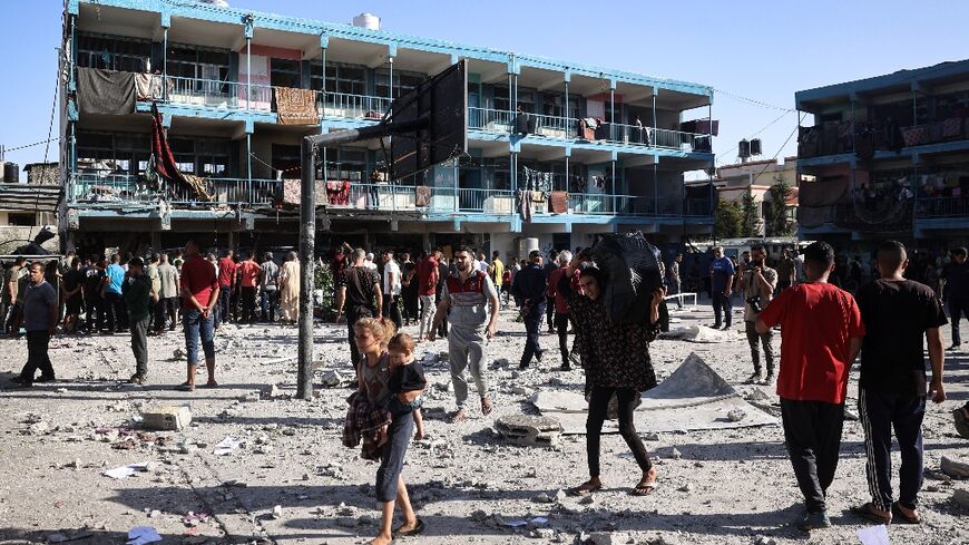 Palestinians in the courtyard of central Gaza's Al-Jawni school after an Israeli air strike