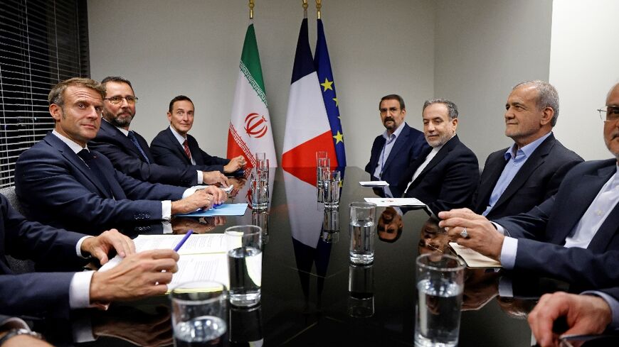 French President Emmanuel Macron (L) meets with Iran's President Masoud Pezeshkian (R) on the sidelines of the United Nations General Assembly