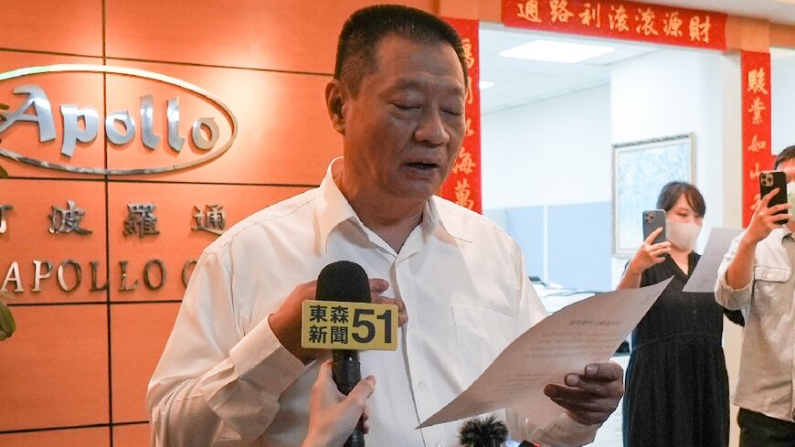 Gold Apollo chief Hsu Ching-kuang  speaks to the media outside the company's office in New Taipei City