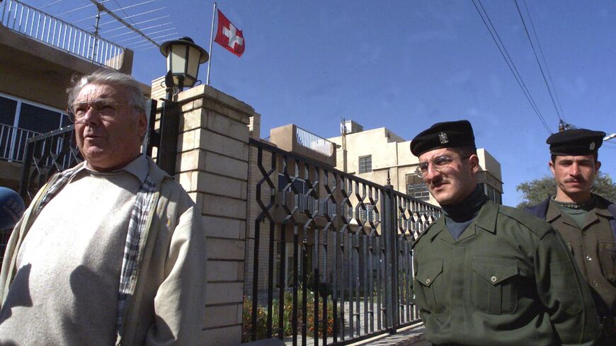 Kurt Reiniger, Swiss diplomat in charge of humanitarian affairs (L), arrives at the Swiss Embassy in Baghdad, on February 2, 2001.