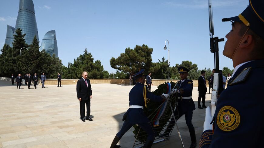 In this pool photograph distributed by Russian state agency Sputnik, Russia's President Vladimir Putin attends a wreath-laying ceremony at the Eternal Flame Memorial in Baku on August 19, 2024. (Photo by Mikhail TERESHCHENKO / POOL / AFP) (Photo by MIKHAIL TERESHCHENKO/POOL/AFP via Getty Images)