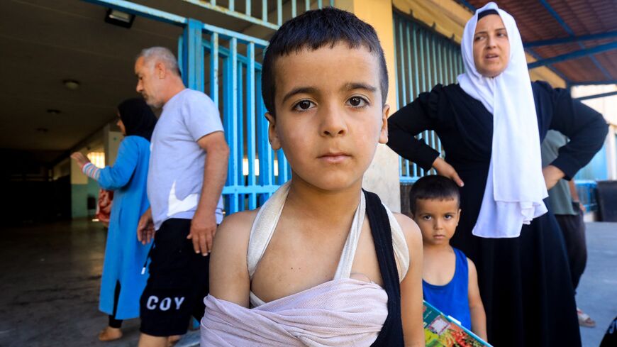 An injured child and others at a school in Beirut housing displaced people who fled Israeli strikes in southern Lebanon, Sep. 26, 2024.