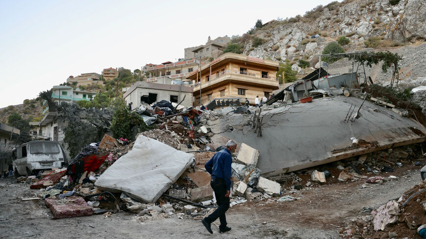 A man checks the destruction following an overnight Israeli airstrike in the southern Lebanese village of Shebaa near along the border between the two countries, on Sept. 27, 2024.