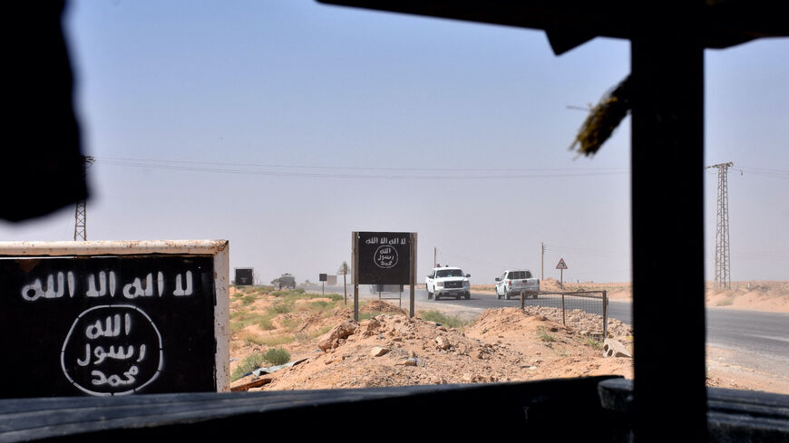 Billboards show the logo of the Islamic State (IS) group near the village of al-Maleha, in the northern countryside of Deir Ezzor, where Syrian pro-government forces are holding a position on Sept. 9, 2017, during the ongoing battle against IS jihadists. 