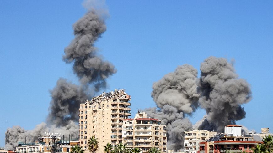 Plumes of back smoke rise over the Lebanese coastal city of Tyre after Israeli air strikes