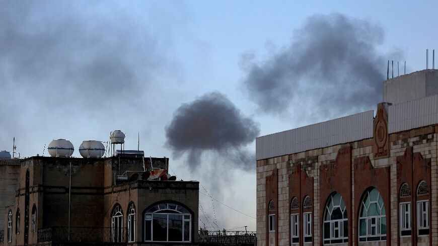 Smoke billows in the Yemeni capital of Sanaa following US military strikes aimed at Huthi targets on October 4, 2024