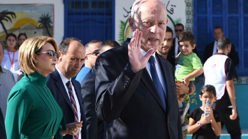 Tunisia's President Kais Saied waves outside a polling station in Tunis after casting his vote in the affluent Ennasr neighbourhood