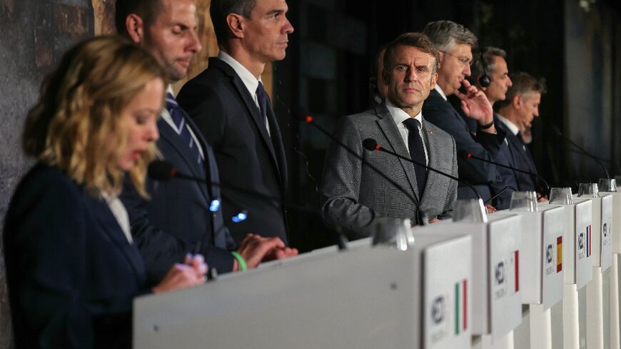 French President Emmanuel Macron looks at Italy's Prime Minister Giorgia Meloni speaking during a press conference after the MED9 summit in the Cypriot city of Paphos 