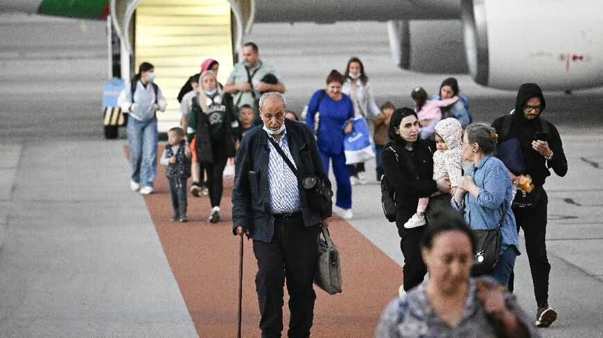 Passengers disembark a Bulgarian government evacuation flight from Lebanon