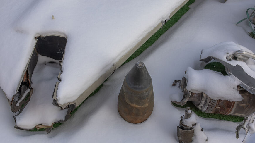 This photograph taken on January 16, 2024, shows partly covered in snow the wreckage of Iranian made Shahed drone launched at Ukraine, at Kyiv Scientific Research Institute of Forensic Expertise, in Kyiv, amid the Russian invasion of Ukraine. At a research facility in Kyiv, forensic experts pour over the wreckage of missiles, working to confirm that despite unprecedented sanctions, Russia is still using imported components to attack Ukraine. The courtyard of the Kyiv Scientific Research Institute of Forensi