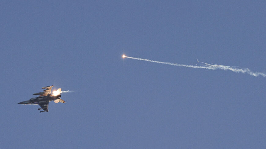 This picture taken from a position in northern Israel shows an Israeli Air Force fighter jet firing flares as it flies to intercept a hostile craft that launched from Lebanon over the border area with south Lebanon on July 7, 2024, amid ongoing cross-border clashes between Israeli troops and Hezbollah fighters. (Photo by Jalaa MAREY / AFP) (Photo by JALAA MAREY/AFP via Getty Images)