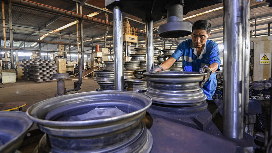 An employee works on a steel wheel production line at a factory in Qingzhou, in eastern China's Shandong province on Sept. 27, 2024. 