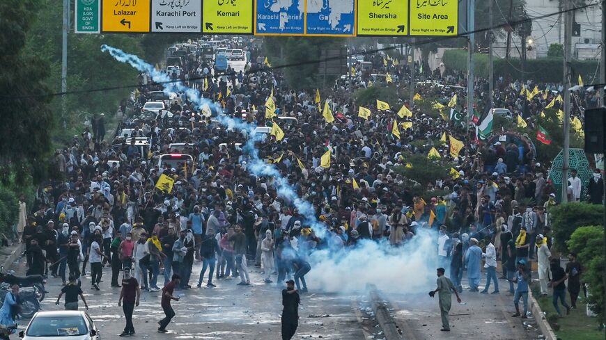 Members of Imamia Students Organization, a Shiite Muslim student wing, take part in a protest to condemn the killing of Hassan Nasrallah, as policemen fire tear gas shells to disperse them in Karachi on Sept. 29, 2024.