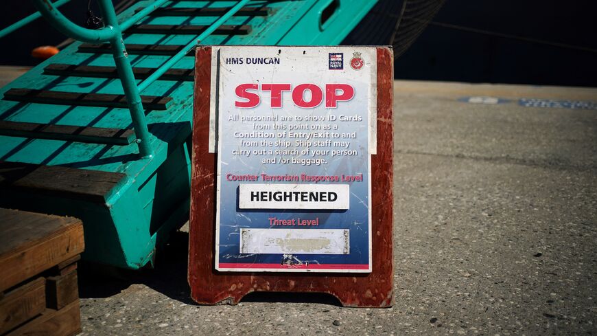 A sign about the heightened level of the counterterrorism response is seen outside HMS Duncan while docked at the Port of Limassol on the Mediterranean island of Cyprus, on Oct. 2, 2024. 