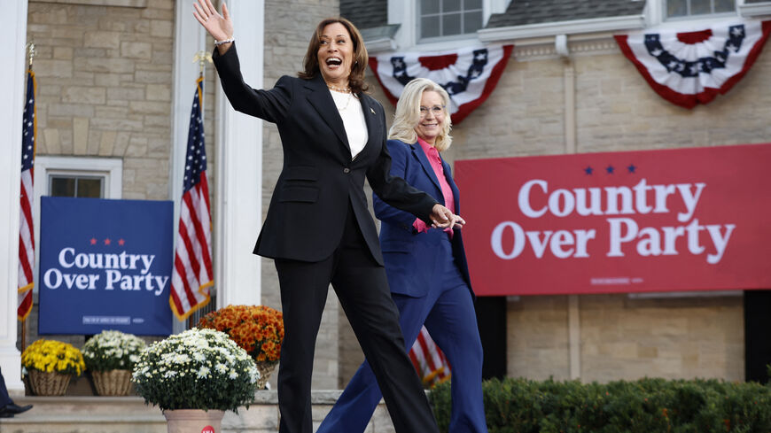 TOPSHOT - US Vice President and Democratic presidential candidate Kamala Harris and former US Representative Liz Cheney (R) arrive for a campaign event at Ripon College in Ripon, Wisconsin, October 3, 2024. (Photo by KAMIL KRZACZYNSKI / AFP) (Photo by KAMIL KRZACZYNSKI/AFP via Getty Images)