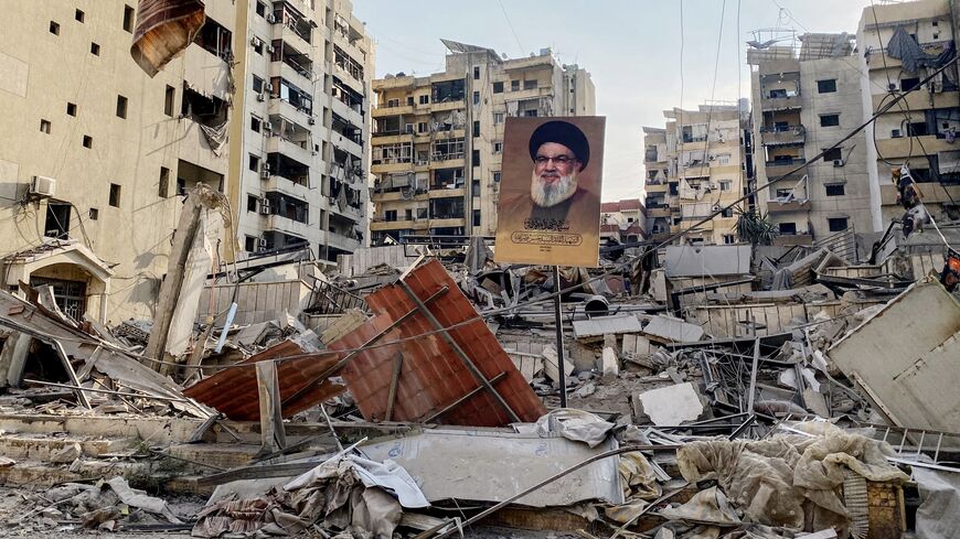 A portrait of slain Hezbollah leader Hassan Nasrallah sits amid debris at Beirut's southern suburb Rouweiss neighborhood on Oct. 10, 2024, following overnight Israeli strikes. 